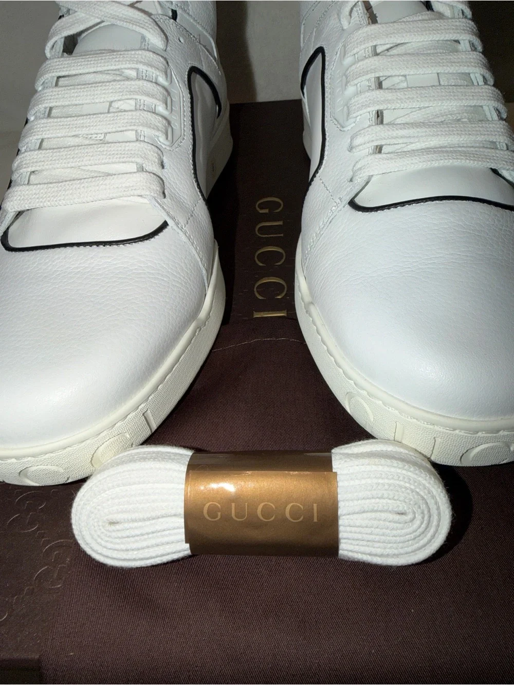 Gucci White Leather Low-Top Sneakers with Red Logo Sole.